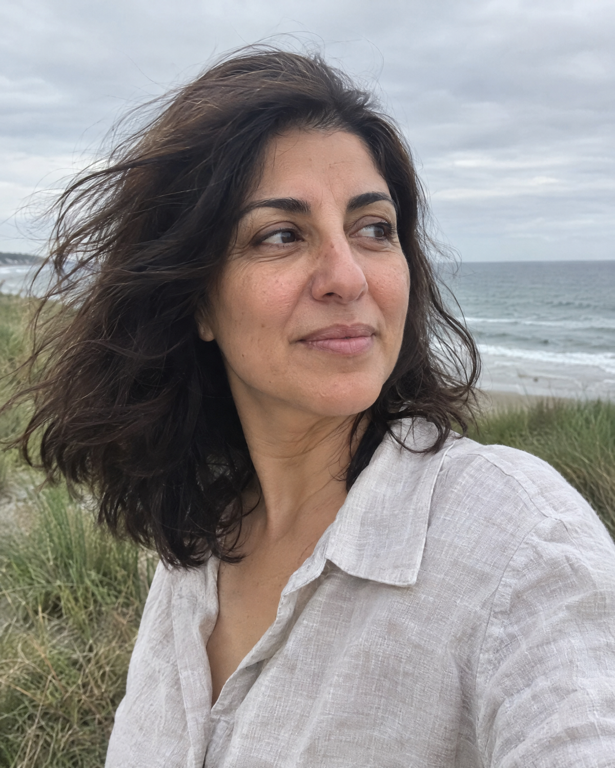 Woman with her hair down on a windy coastal walk